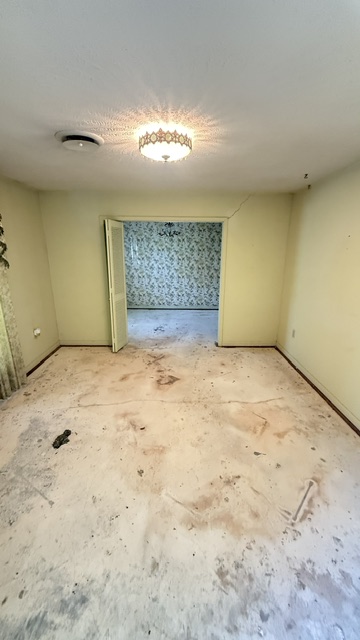 Same living room emptied and swept clean after Quick and Clear cleanout