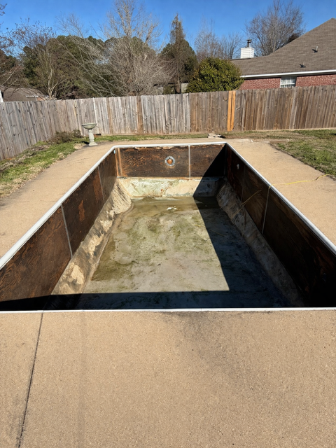 Backyard in-ground pool drained and prepped for demolition