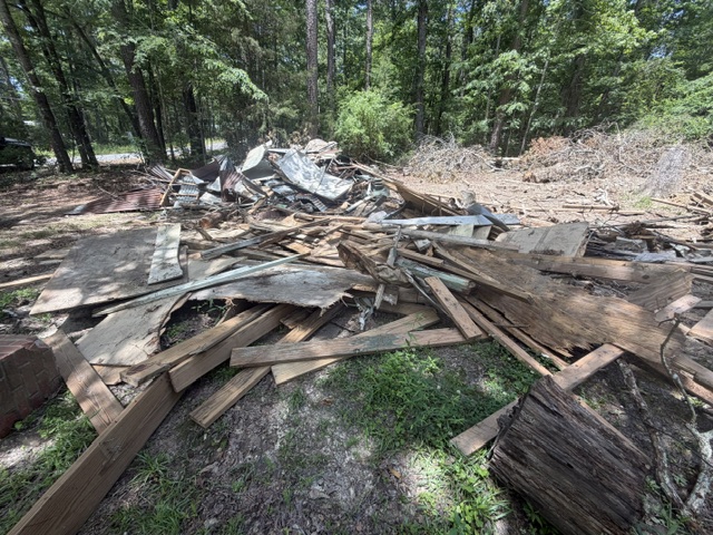 Pile of wood and structural debris from demolition before haul-off
